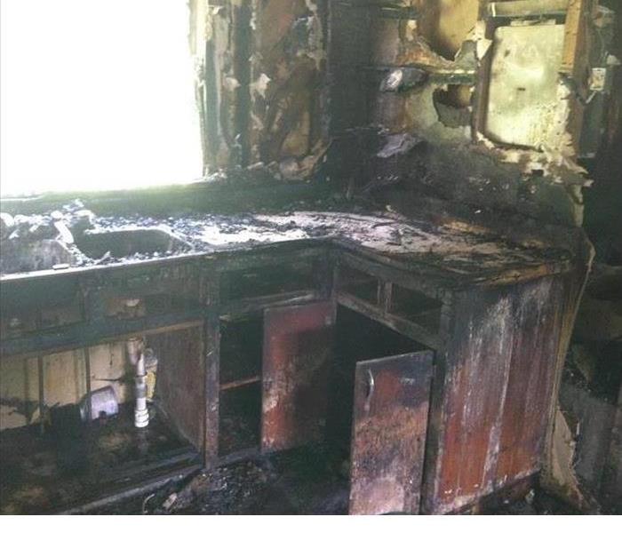 Fire damage to wall and kitchen counters.