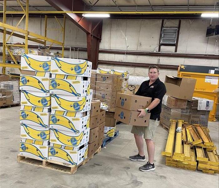 Man lifts box of bananas at ICCAPs new facility in Indiana County
